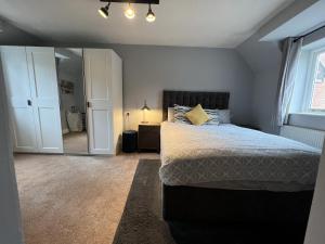 a bedroom with a large bed and a window at Tailor That Property - High Street in Northampton