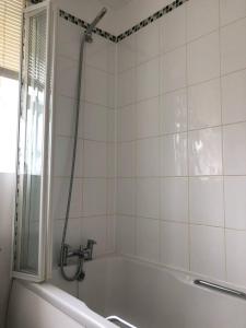 a bathroom with a bath tub with a shower at Bluebell House 2 bedroom with parking and garden in Scunthorpe
