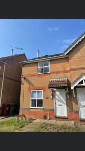 a brick house with two windows and a porch at Bluebell House 2 bedroom with parking and garden in Scunthorpe