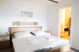 sypialnia z dużym łóżkiem z białą pościelą w obiekcie Himmelsglück w mieście Lam