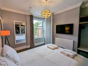 a bedroom with a bed with two pillows on it at Robert Bolt House in Sale