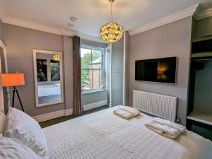 a bedroom with a bed with two pillows on it at Robert Bolt House, Free Parking, 1 Minute to Metrolink in Sale