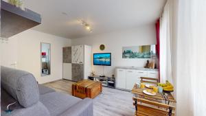 a living room with a couch and a table at Studio Schilick in Schiltigheim