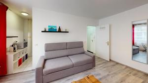 a living room with a couch and a kitchen at Studio Schilick in Schiltigheim
