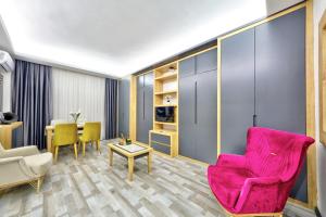 a living room with a pink chair and a table at North Blue Life in Istanbul