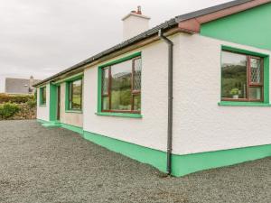 a row of houses with green windows at Drumore House in Ballyhoorisky