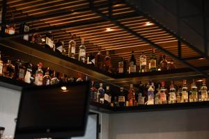 a shelf filled with lots of bottles of alcohol at BAZ'HUR Boutique Hotel in Kukës