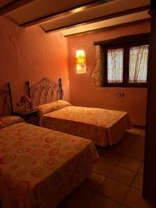 - une chambre avec 2 lits et une fenêtre dans l'établissement Ven-Al-Azahar, à Enguera