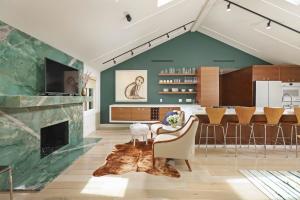 a living room with a fireplace and a dining room at Green Cottage in Los Angeles