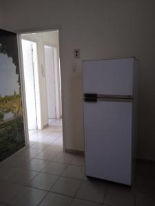 a kitchen with a white refrigerator in a room at COMFORT RENT in Lamía