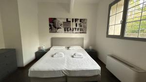a bedroom with a bed with two towels on it at Vacanze romane in Rome