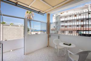 a balcony with a table and chairs and a view of the ocean at Estudio 2 Costa Adeje in Adeje