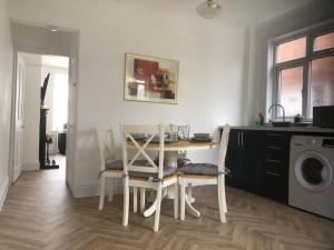 a dining room with a table and chairs and a washing machine at 15 Comfort House 2 bed townhouse with parking in Scunthorpe