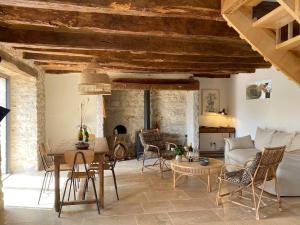 a living room with a table and chairs at Le Domaine Quercus in Sénaillac-Lauzès