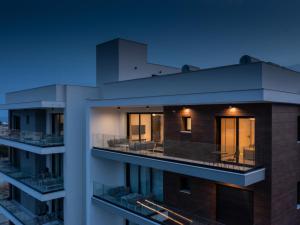 an apartment building with a balcony at night at Sanders Elgio in Limassol +23 photos