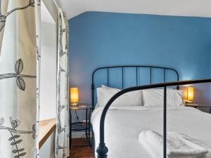 a bedroom with a bed with a blue ceiling at Pass the Keys Quaint Cottage Retreat in Charming Ulverston in Ulverston