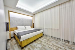 a bedroom with a king sized bed and a window at North Blue Life in Istanbul