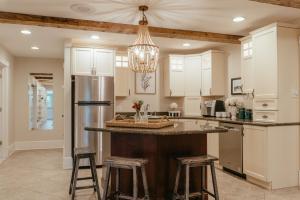 a kitchen with a large island with bar stools at 68CP Luxury farmhouse at the award-winning Bellevue Barn, 2 min to Santa's Village, AC, fireplace in Jefferson