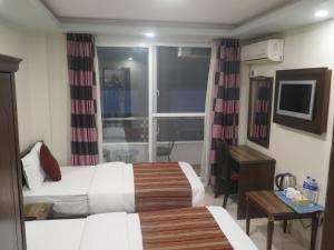 Rúm í herbergi á Hotel Pipal Tree