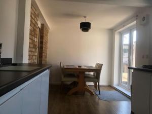 a kitchen with a table and chairs and a window at Bellingham house 3 bedroom home in Brumby +1 photo