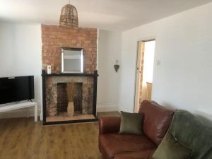 a living room with a couch and a fireplace at Bellingham house 3 bedroom home in Brumby