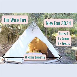 a white tent with a sign that reads the wild tipip new for at Loire Valley Llama Farm Stay in Lavernat