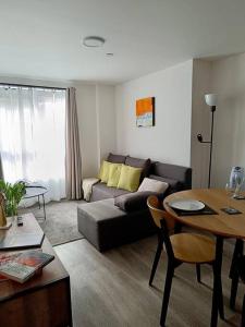 a living room with a couch and a table at Modern & Centrally Located Apartment in Liverpool