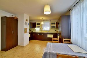 a kitchen and dining room with a table and a dining room gmaxwell gmaxwell at Holiday house Malšice in Malšice