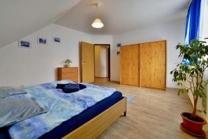 1 dormitorio con 1 cama y una maceta en Holiday house Malšice, en Malšice