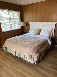 a bedroom with a large bed with a large window at Mountain View Cabins in Wrightwood