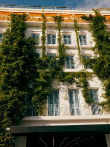 a building with ivy growing on the side of it at Rooms Hotel Batumi in Batumi