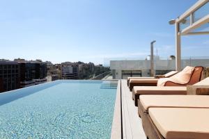 a swimming pool on the roof of a building at LUX&EASY Signature Syggrou 234 in Athens