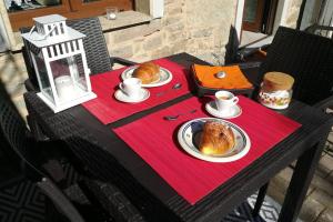 a table with two plates of croissants and coffee on it at Appartamento Poli con giardino in Castiglione dei Pepoli