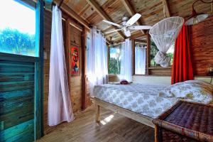 a bedroom with a bed and a ceiling fan at Cabarete Boutique Kite Hotel for up to 15 people in Cabarete