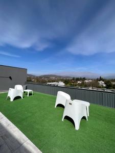 three white benches sitting on top of a roof at Terrazas del Fortín in San Salvador de Jujuy