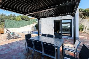 a black table and chairs on a patio at Villa Esperanza in Vidreres