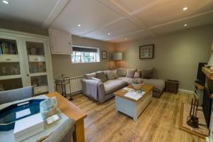 a living room with a couch and a table at Weaver's Cottage in Smarden