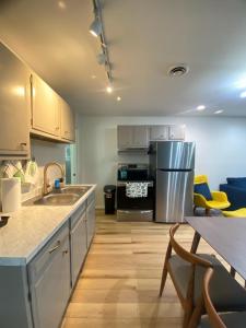 a kitchen with a sink and a refrigerator at The True The Archive Lofts in Marion