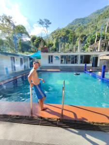 a young boy standing next to a swimming pool at Wake In Himalayas in Pelling