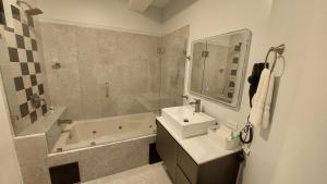 a bathroom with a sink and a bath tub and a sink at Lucky`s Hotel & Casino in San Isidro