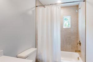 a bathroom with a shower curtain and a toilet at Town of Rehoboth Beach - 99 Sussex St Unit #4 in Rehoboth Beach