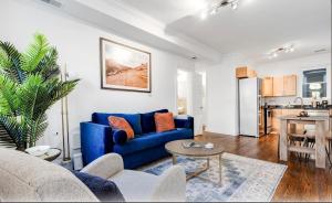 a living room with a blue couch and a table at Entire Rowhome In Northwest Washington in Washington, D.C.