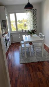 a dining room with a white table and chairs at A stylish, newly decorated home! in Raahe +1 photo