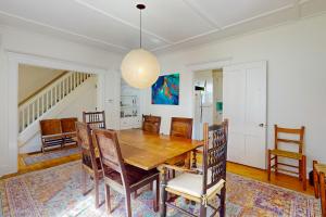 a dining room with a wooden table and chairs at The Farmhouse Back House in Montpelier