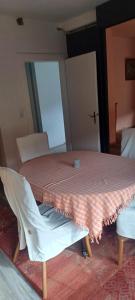 a room with a table and a chair with a red and white table cloth at Haus auf den oberen Hexenstieg in Osterode