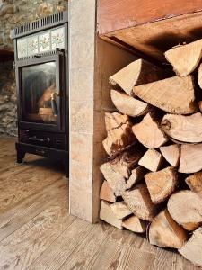 a pile of fire wood next to a fireplace at B&B Terra di confine in Venalzio