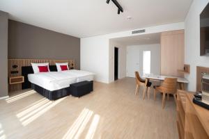 Postel nebo postele na pokoji v ubytování Tailormade Hotel BAB Bachenbülach