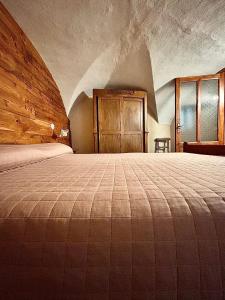 a bedroom with a large bed in a building at B&B Terra di confine in Venalzio