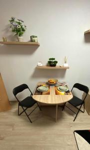 a table and chairs in a living room at Danka Szálláshely in Debrecen