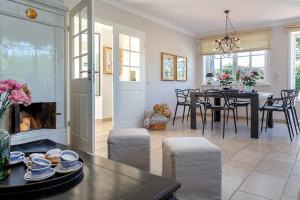 a dining room and living room with a table and chairs at Haus Traumzeit in Braderup